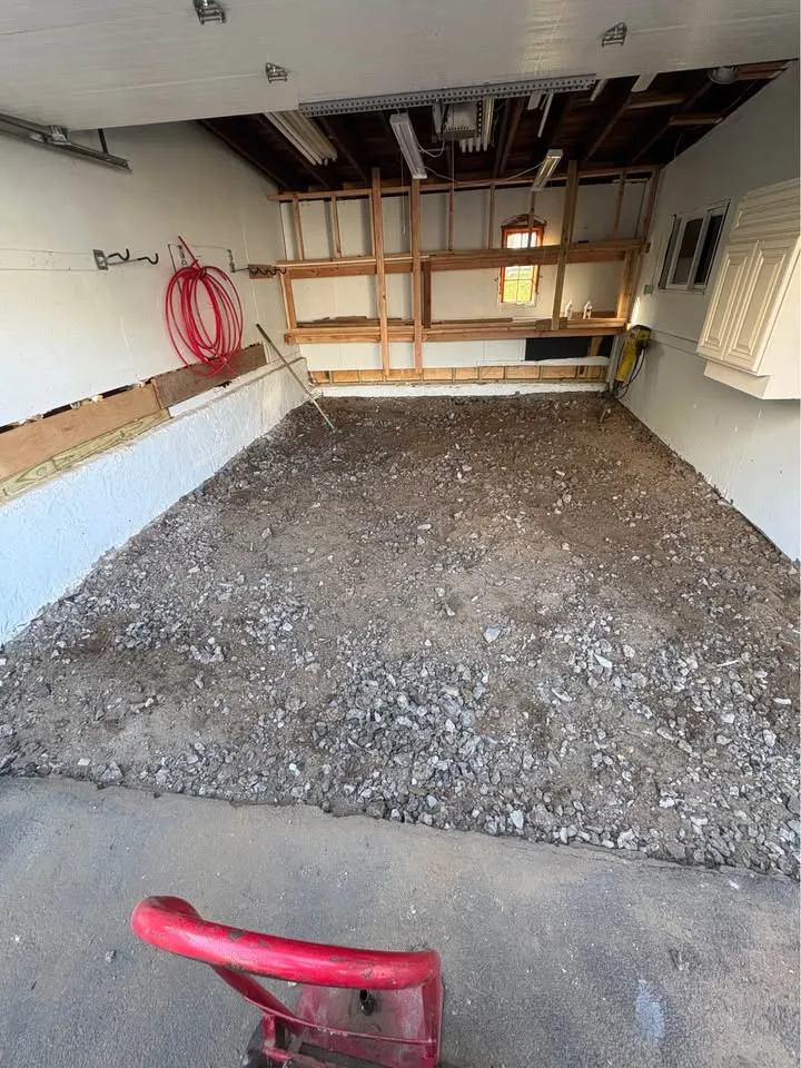 Garage floor covered with compacted granular material