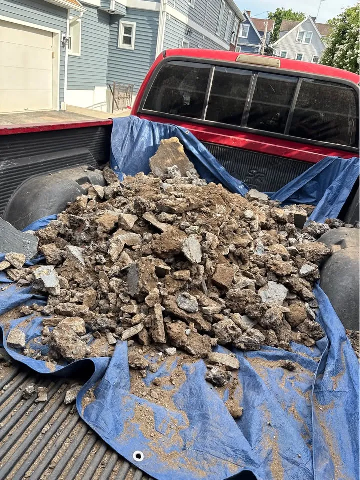 Broken concrete loaded onto a tarp