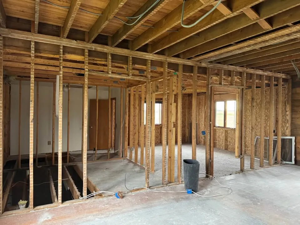 Room stripped back to wood framing