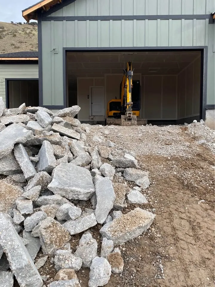 Broken concrete pieces staged inside a garage opening