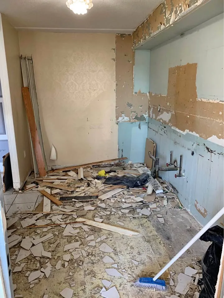 Bathroom wall finish removed in one work area