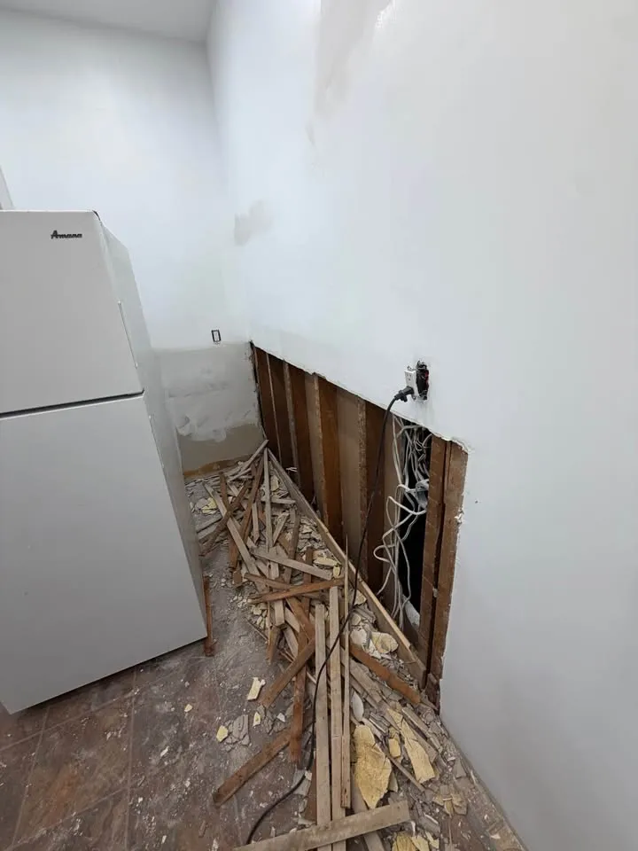 Lower wall opened around visible electrical wiring