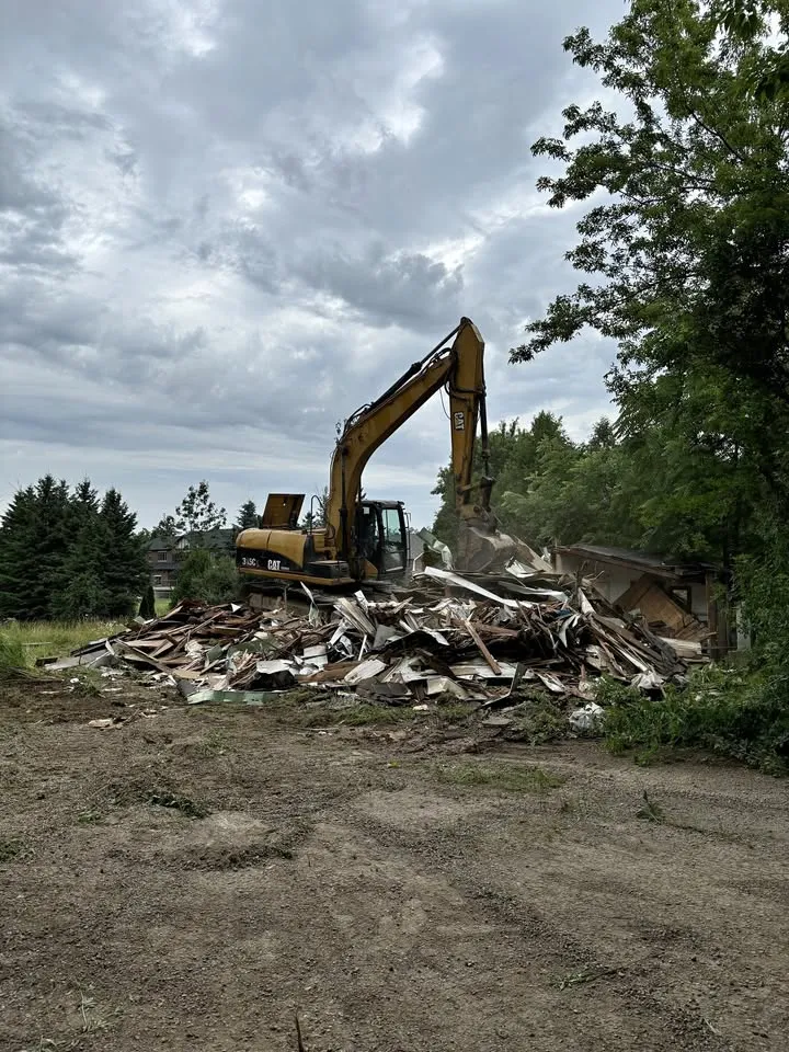 Excavator sorting structural demolition debris
